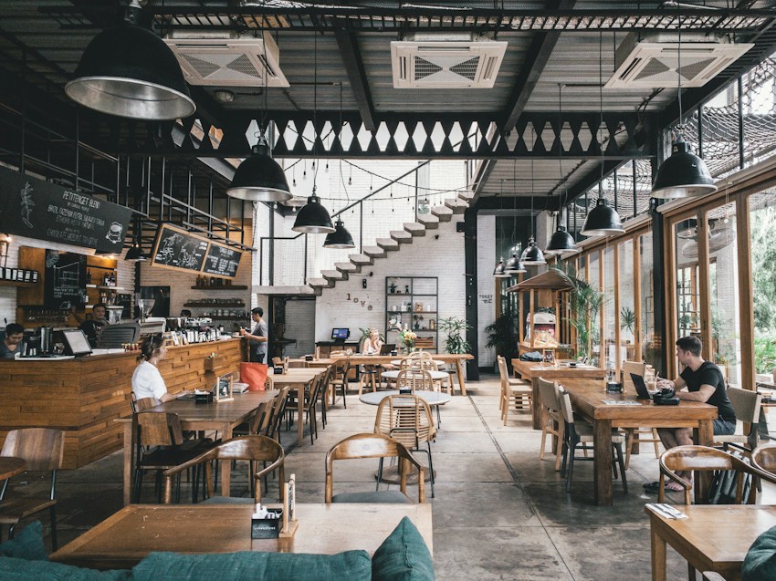 A neighbourhood café with wooden tables and a busy counter